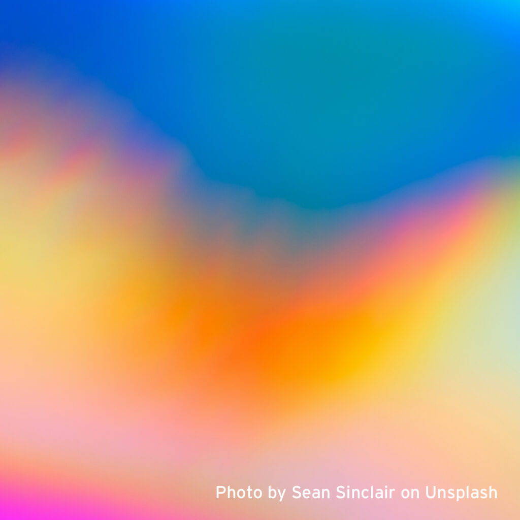 Blurry image of a rainbow colored background