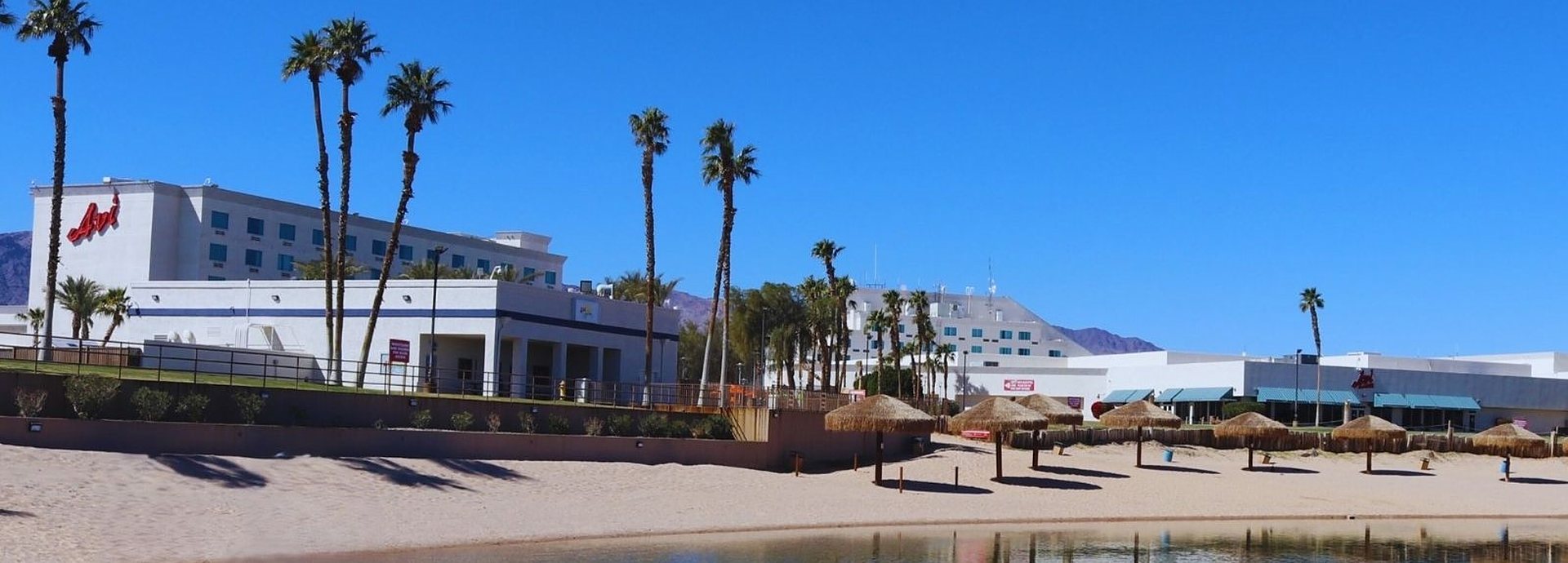 Avi Resort & Casino in Laughlin, Nevada, seen from its palm-lined private beach on the Colorado River