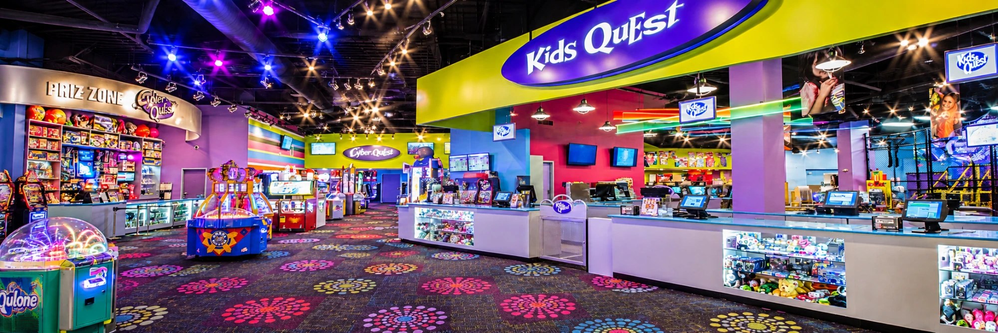 A Kids Quest and Cyber Quest center with the bright Kids Quest check-in counter, arcade games and the Prize Zone