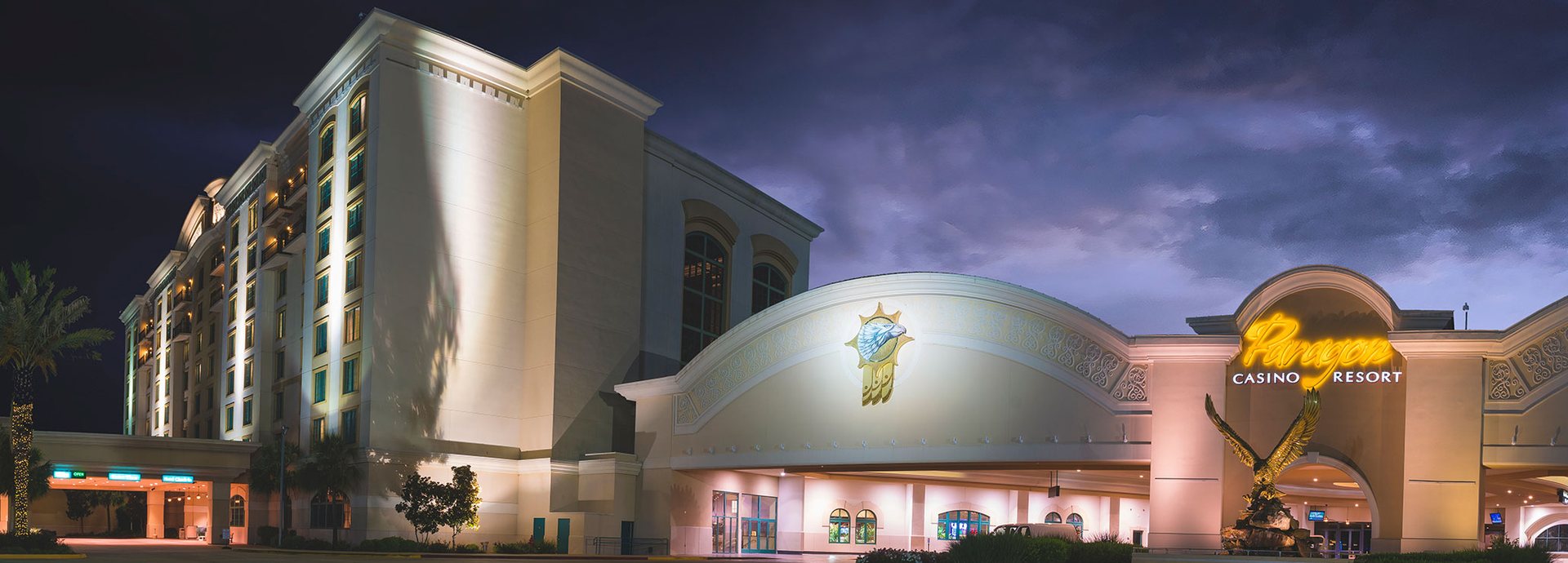 Paragon Casino Resort in Marksville, Louisiana, at dusk, with the lit hotel tower and domed casino entrance