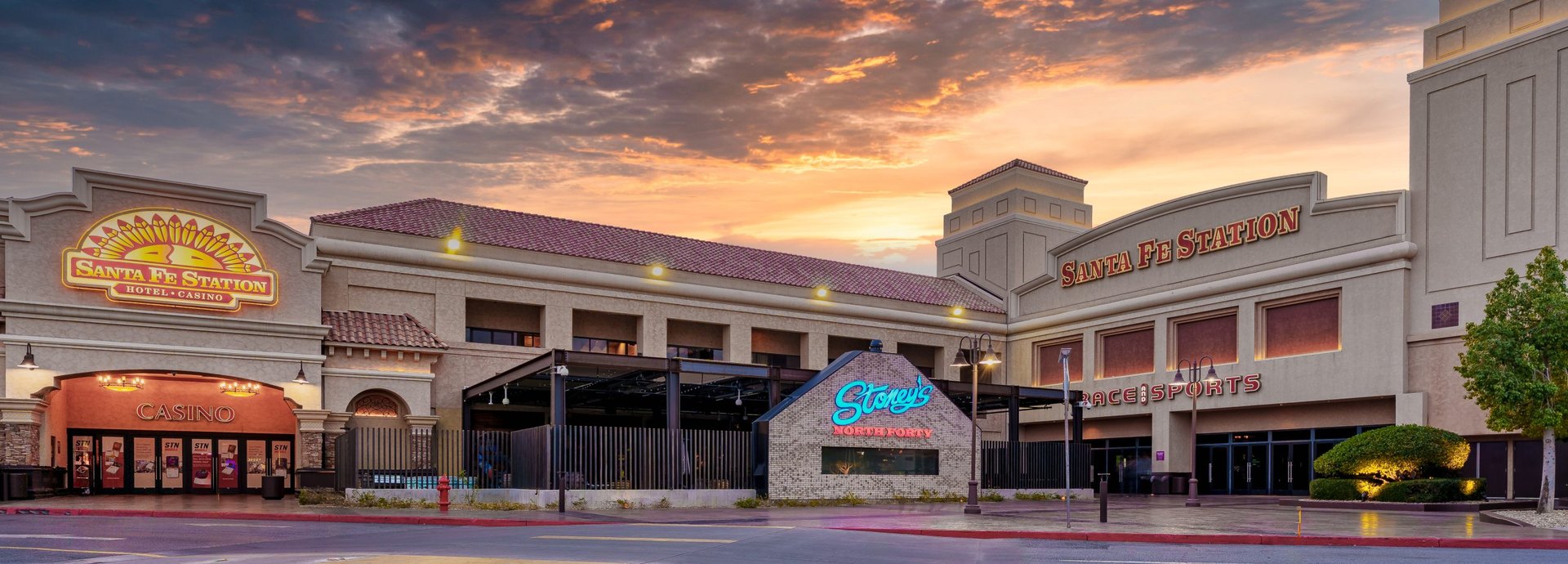 The Santa Fe Station hotel and casino entrance under a fiery sunset sky in Las Vegas