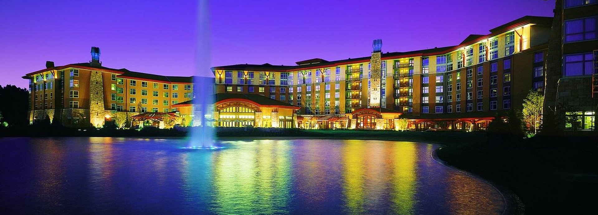 Soaring Eagle Casino & Resort in Mount Pleasant, Michigan, lit up at dusk behind its fountain pond